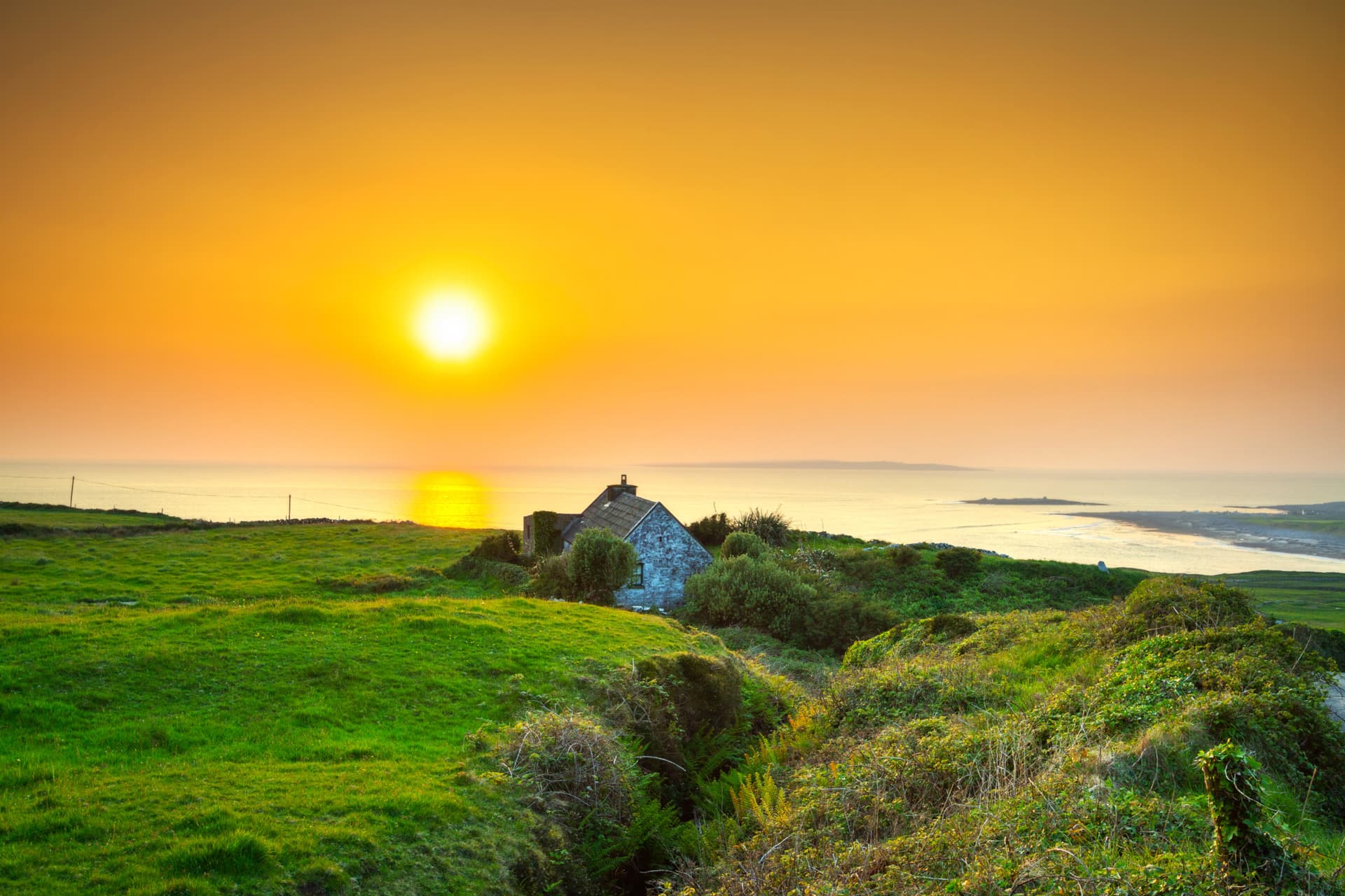 A whitewashed cottage on the limestone coast of the Burren, County Clare